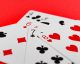 Casino gaming blackjack table with basic strategy card visible next to player chips on green felt